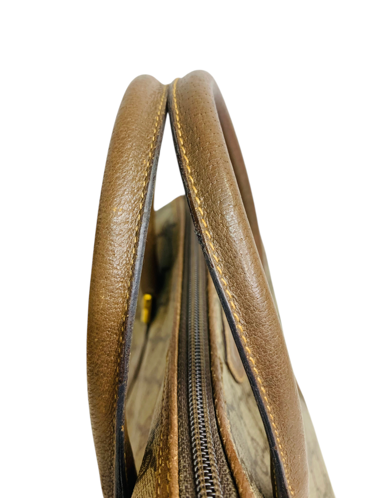 Cherry's Luxury Collection brown leather handbag handles with detailed stitching and a top zipper closure.