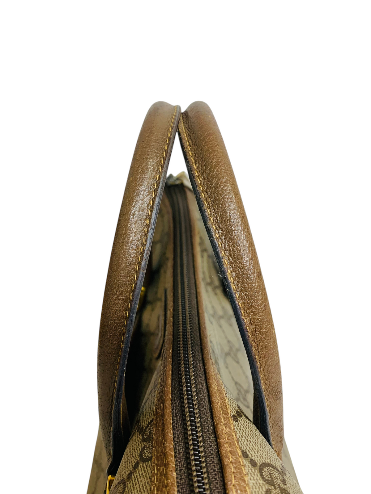 Cherry's Luxury Collection Gucci handbag top view showing brown leather handles and monogram canvas zipper closure