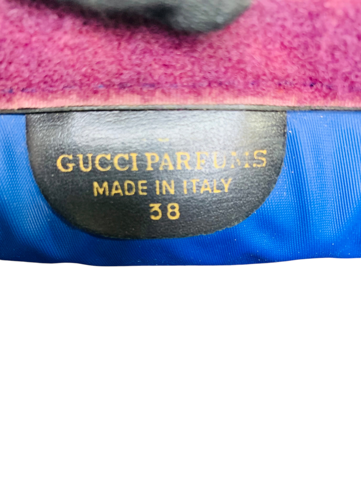 Cherry's Luxury Collection Gucci Parfums label inside a blue nylon bag with a purple velvet trim.