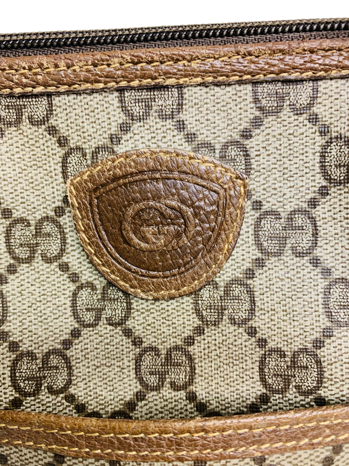 Cherry's Luxury Collection Gucci monogram canvas handbag with brown leather trim and embossed logo patch detail.