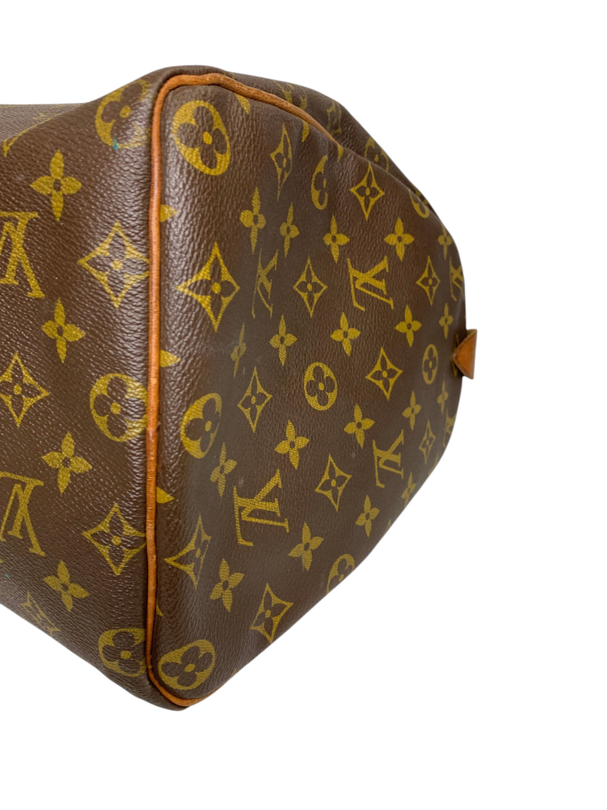 Close-up of a brown monogram coated canvas travel duffel bag with tan leather piping and structured side profile.
