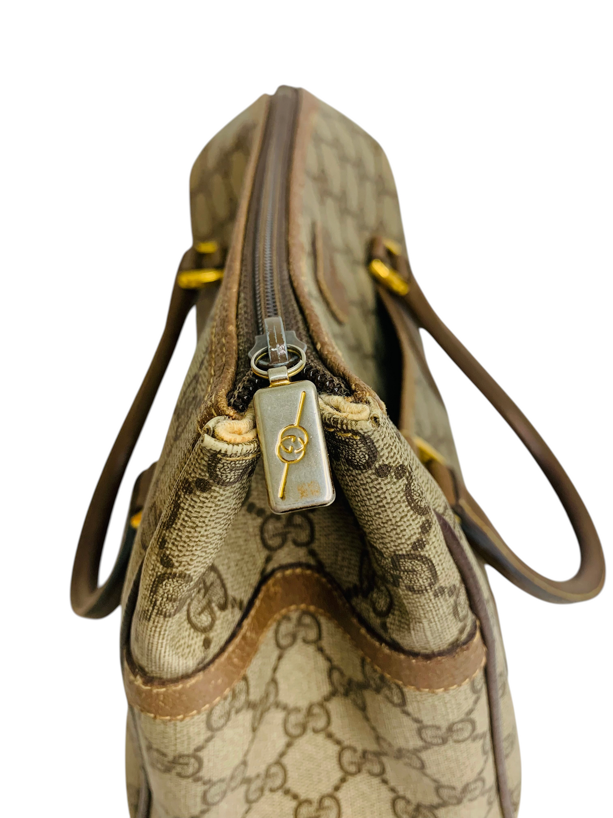 Cherry's Luxury Collection vintage Gucci monogram canvas handbag with gold-tone logo zipper pull detail.
