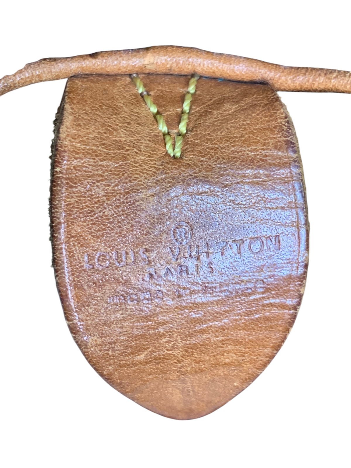 Louis Vuitton monogram canvas travel bag leather tab with embossed logo and stitching detail